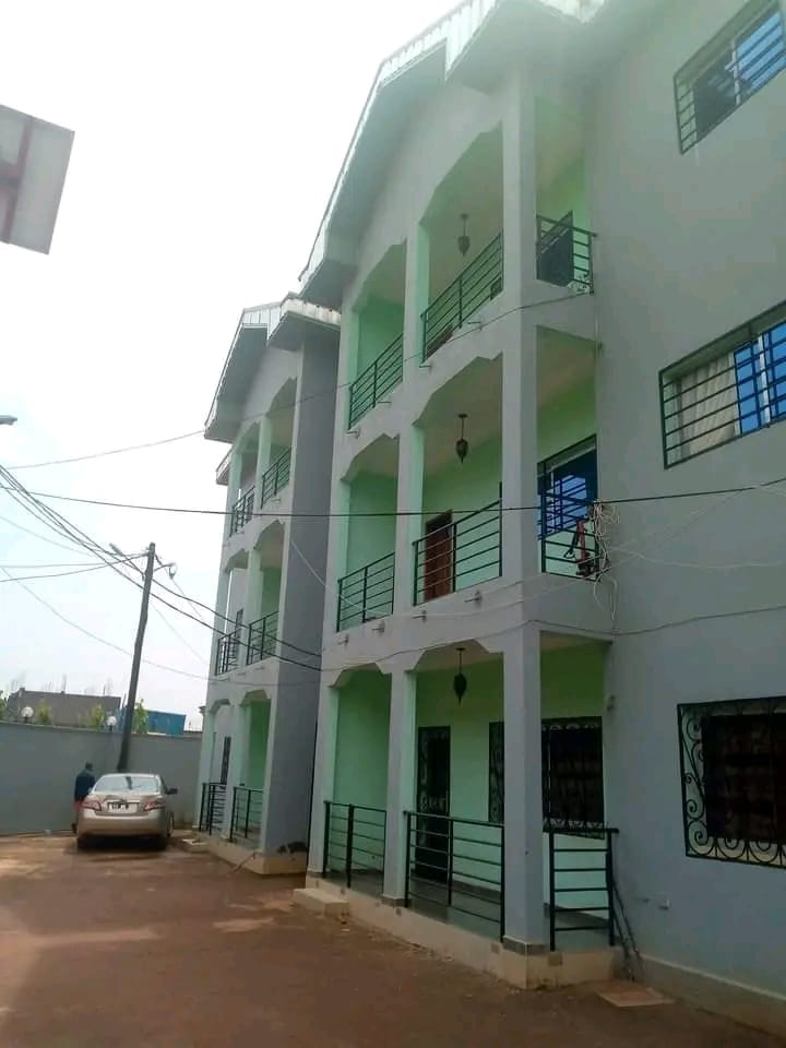 Side view of the building with parking space inside the gated compound