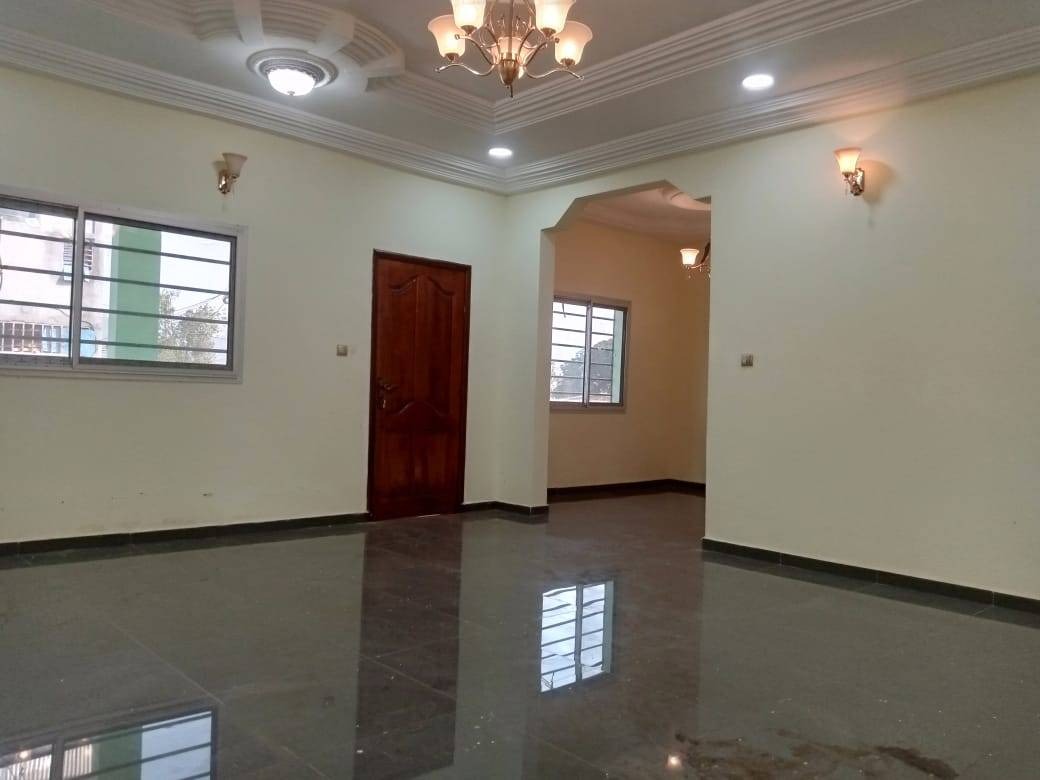 Second reception room with archway, chandelier and large windows