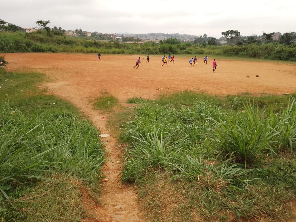 Wide view of the flat Ahala Barrier land with a footpath and distant buildings